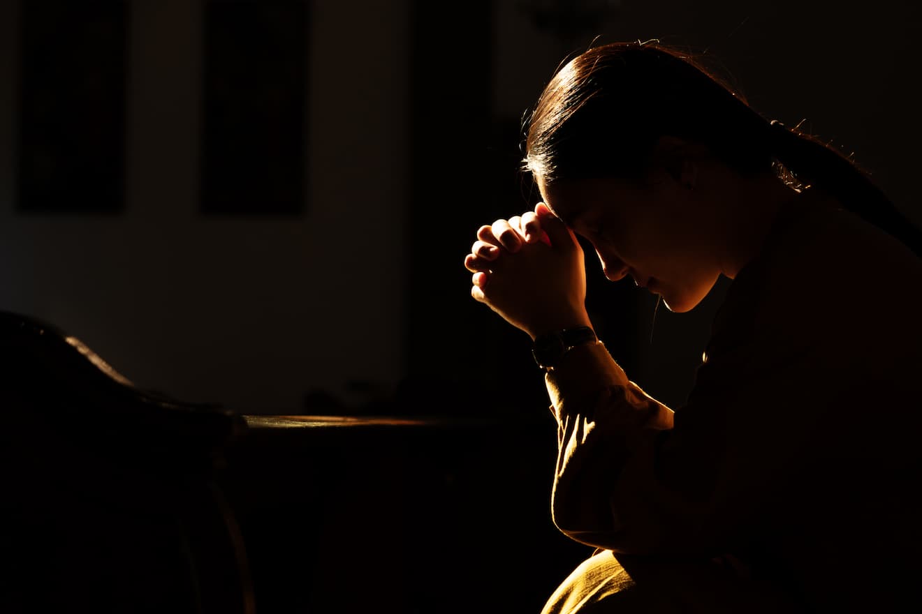 Woman in prayer in a church