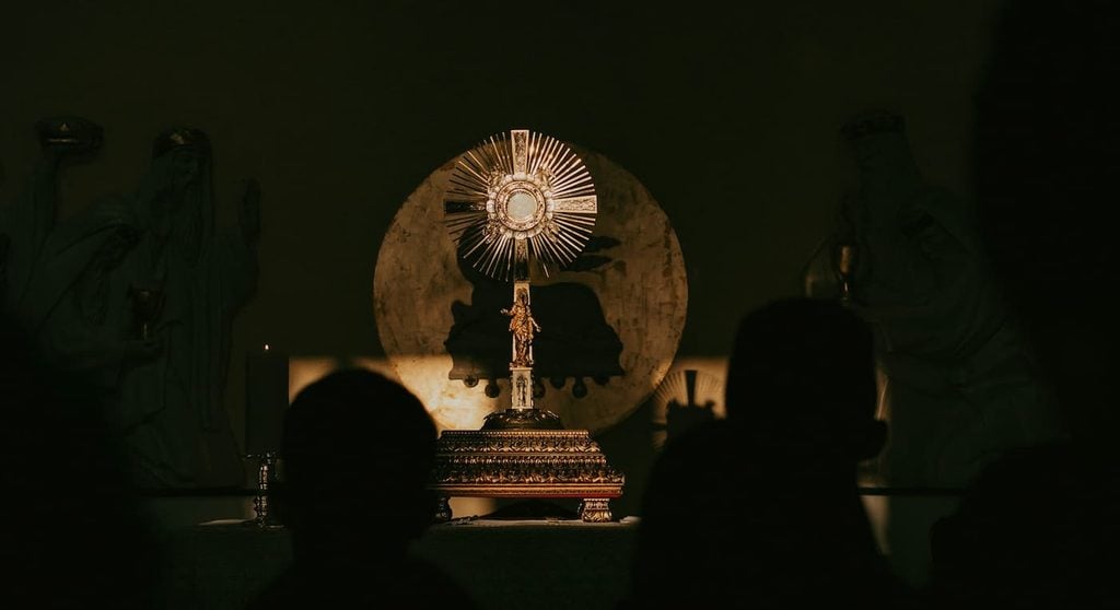 people in adoration before the blessed sacrament